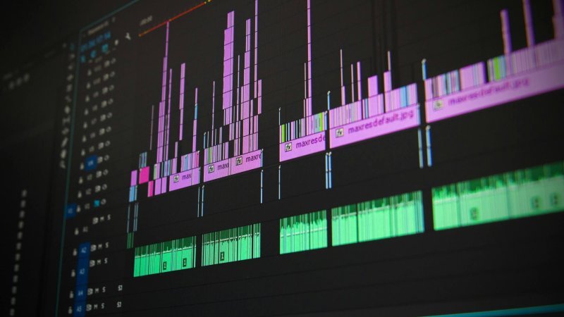Close-up of a professional audio and video editing software interface with waveform displays.